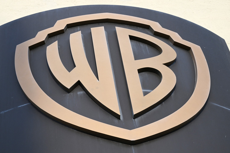 The WB logo is seen on the exterior of Warner Bros. Studios, Burbank in Burbank, California on October 21, 2025. Warner Bros. Discovery, the owner of HBO, CNN and other streaming and studio businesses, said October 21, 2025 it is putting itself up for sale. In a press release, the company announced 