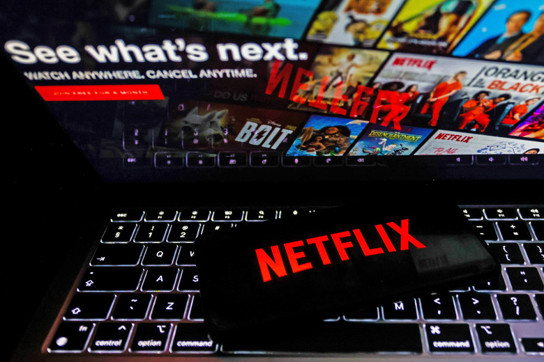 Netflix logo is displayed on a mobile phone screen with Netflix website in a background for illustration photo. Krakow, Poland on January 23, 2023. (Photo by )