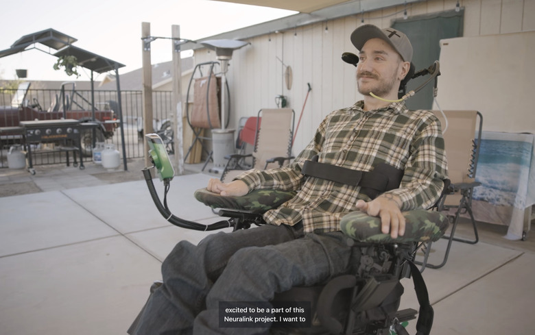 A man strapped to a wheelchair.