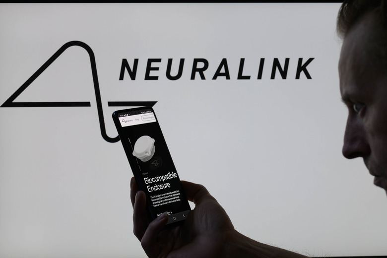 The Neuralink website is being displayed on a smartphone with the Neuralink logo visible in the background in this photo illustration taken in Brussels, Belgium, on May 10, 2024. (Photo by Jonathan Raa/NurPhoto via Getty Images)