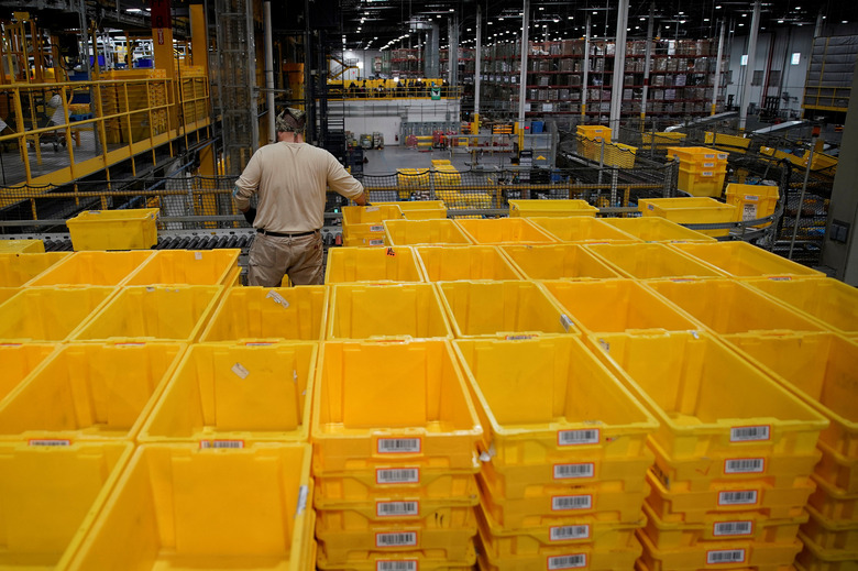 A worker organizes empty bins during Cyber Monday at the Amazon fulfillment center in Robbinsville Township in New Jersey, U.S., November 28, 2022. REUTERS/Eduardo Munoz