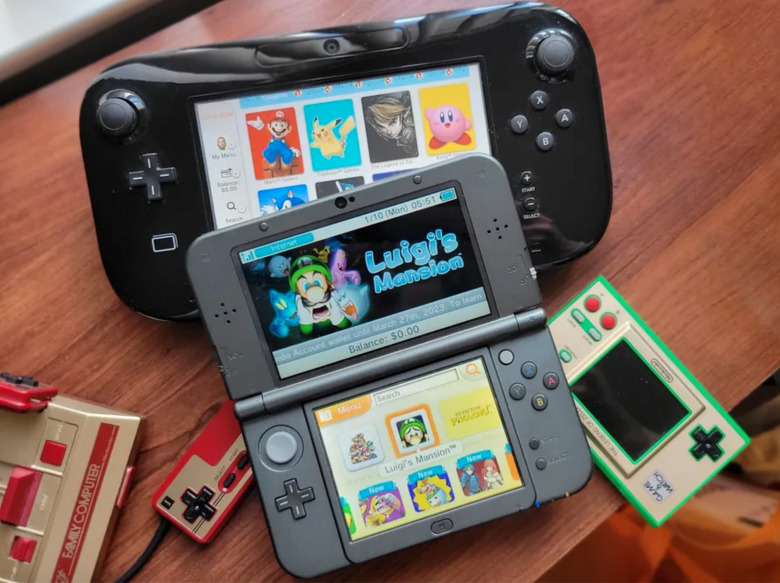 A Wii U and 3DS console on a table. 