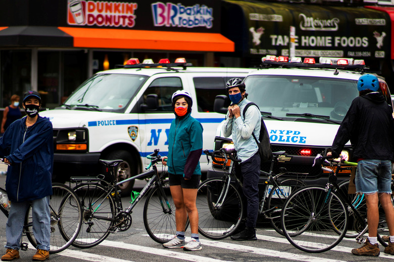 Demonstrators block the NYPD vans to follow them with their bikes as they take part in a protest against racial inequality and in support of the Black Lives Matter movement in Brooklyn, New York, U.S., August 16, 2020. REUTERS/Eduardo Munoz