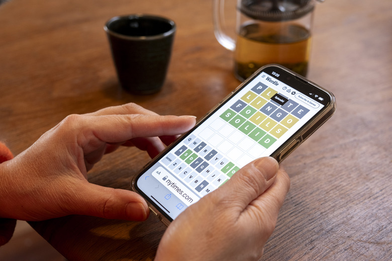 Woman plays Wordle on her smartphone at the kitchen table of her home on 26th November 2023 in Birmingham, United Kingdom. Wordle is a web-based word game played by millions of users / players worldwide often on their mobile devices. The game was created and developed by software engineer Josh Wardle, and owned by The New York Times Company since 2022. (photo by Mike Kemp/In Pictures via Getty Images)