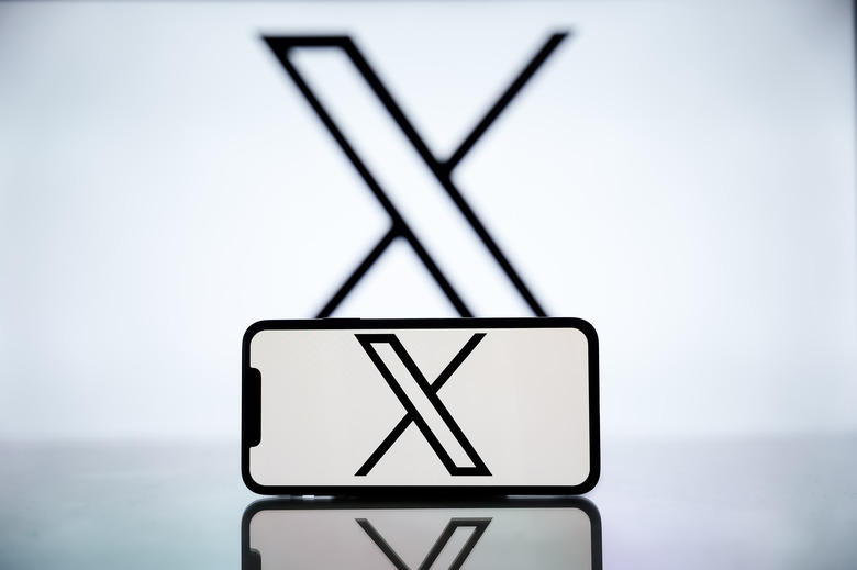 INDIA - 2024/04/27: In this photo illustration, the X logo is seen displayed on a mobile phone screen and in the background. (Photo Illustration by Idrees Abbas/SOPA Images/LightRocket via Getty Images)