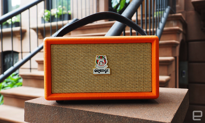 The Orange Amps - Orange Box Bluetooth speaker seen on the stoop of a brownstone, showing the front grille.