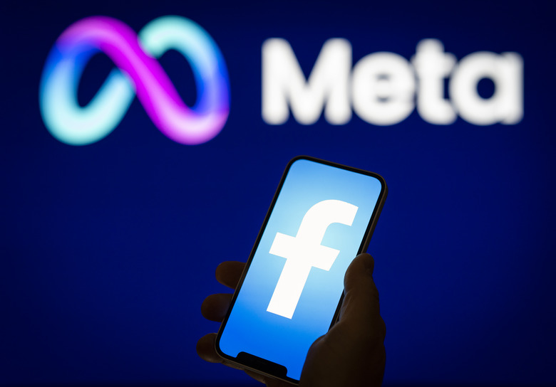 A Facebook logo is seen on a mobile device screen with a Meta logo in the background in this photo illustration on 31 May, 2023 in Warsaw, Poland. (Photo by Jaap Arriens/NurPhoto via Getty Images)