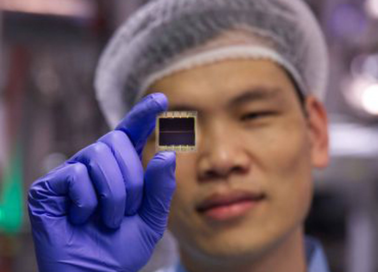 Dr. Shuaifeng Hu, a postdoctoral fellow at Oxford University's physics department, holds up a new solar material that could revolutionize solar energy collection.