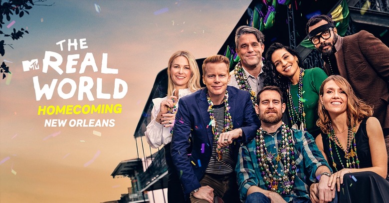 Promo art for “The Real World: Homecoming” reality series, featuring seven middle-aged people posing in front of a beach house.