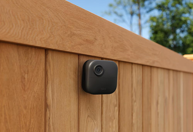 A camera on a wooden fence.