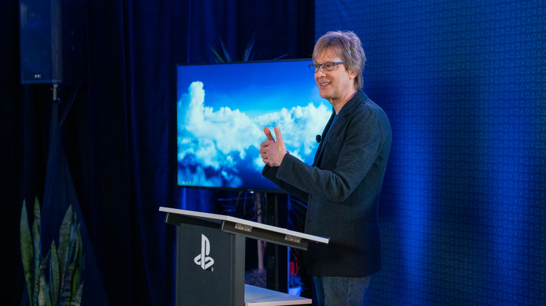 PlayStation Lead Architect Mark Cerny explaining the technical details of the PS5 Pro in front of a podium.