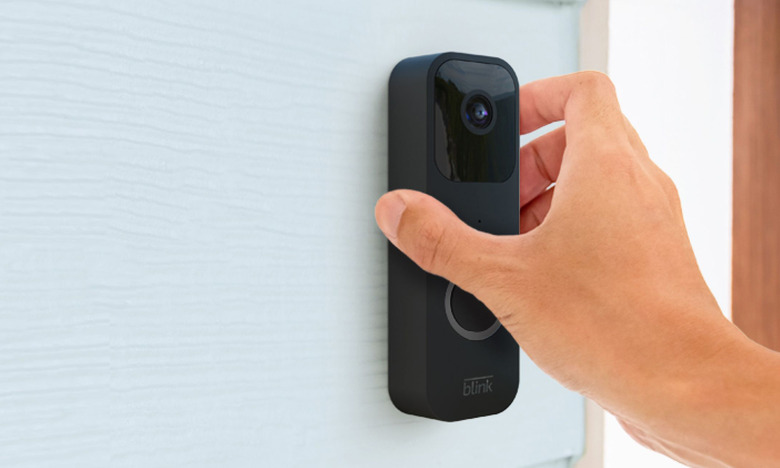 The Blink video doorbell is being installed wirelessly on a house to the side of the front door.  