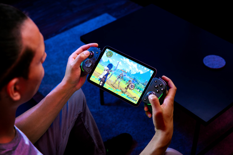 A man using the controller and playing Genshin Impact.