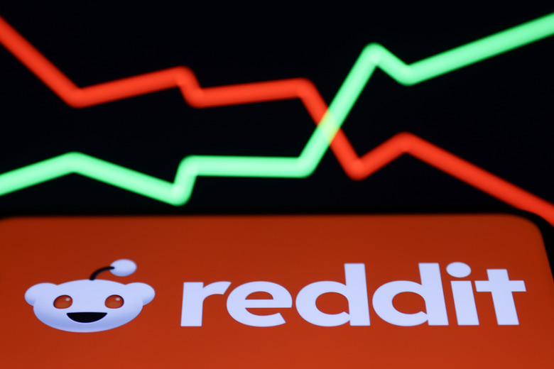 An illustrative stock graph and Reddit logo displayed on a phone screen are seen in this illustration photo taken in Krakow, Poland on February 22, 2024. (Photo by Jakub Porzycki/NurPhoto via Getty Images)