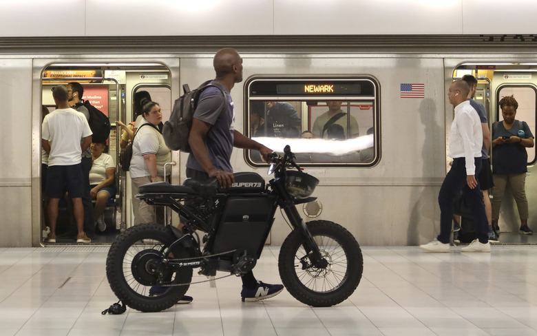 NEW YORK, NY - JULY 17: A man pushes an electric bike along the PATH train platform at the Oculus transit hub at One World Trade Center on July 17, 2023, in New York City.  (Photo by Gary Hershorn/Getty Images)