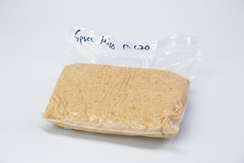 A vacuum sealed package with the ingredients for miso inside, labeled Space Miso in marker