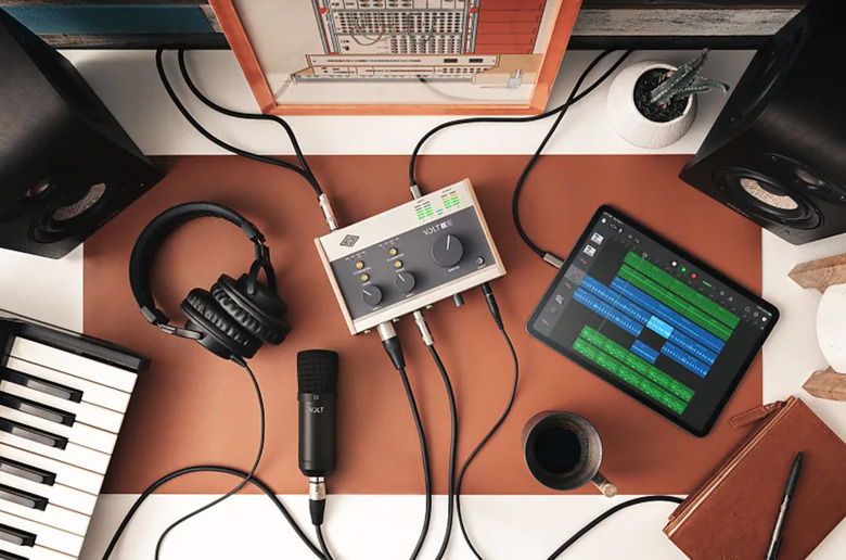 A Volt 276 along with a keyboard, microphone, speakers and headphones.