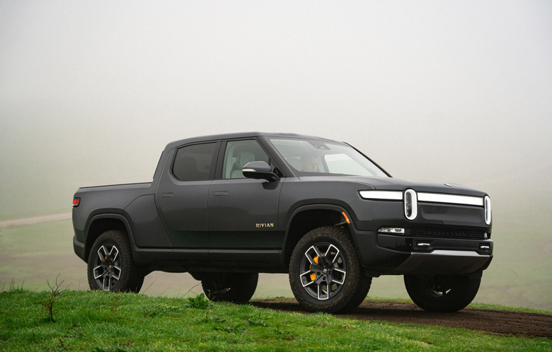 A dark gray truck parked on the grass.