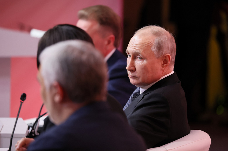 Russian President Vladimir Putin attends the plenary session of the forum 