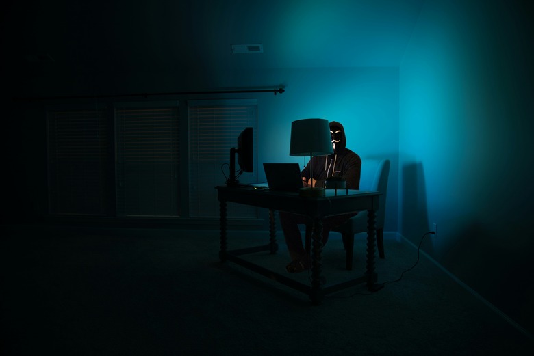 A hacker in a dark room being hacky.