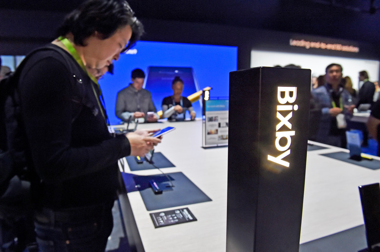 LAS VEGAS, NEVADA - JANUARY 08:  Attendees examine Bixby enabled devices at the Samsung booth during CES 2019 at the Las Vegas Convention Center on January 8, 2019 in Las Vegas, Nevada. CES, the world's largest annual consumer technology trade show, runs through January 11 and features about 4,500 exhibitors showing off their latest products and services to more than 180,000 attendees. (Photo by )