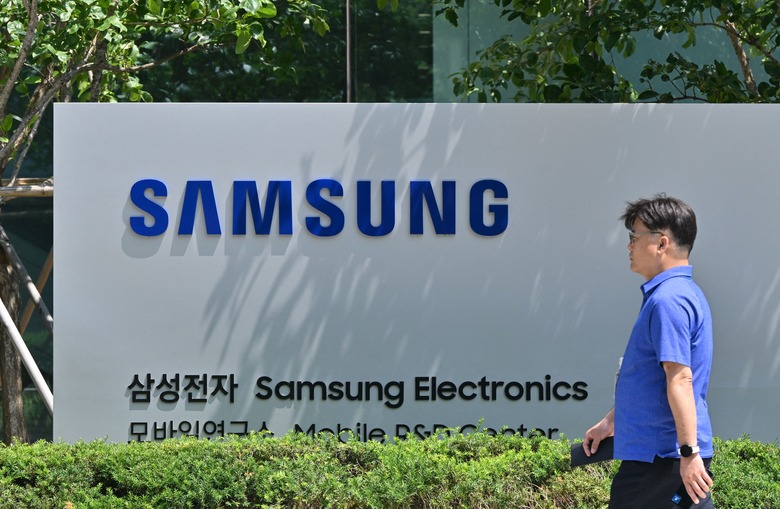 A man walks past the logo of Samsung Electronics at the company's headquarters in Suwon on June 13, 2023. (Photo by Jung Yeon-je / AFP) (Photo by JUNG YEON-JE/AFP via Getty Images)