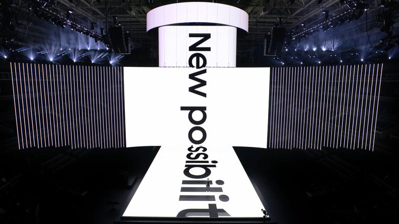 Still from the stream of Samsung’s January 2024 Unpacked event in California. The stage and screen above it show a marquee with the words 