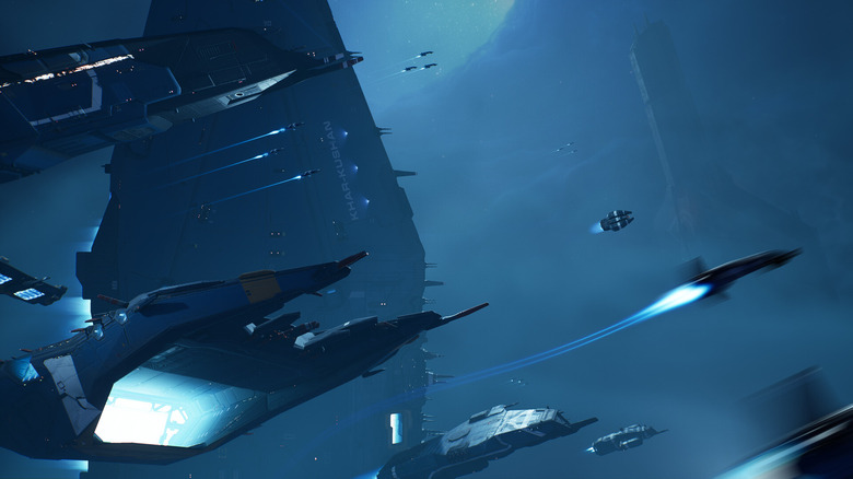 Several spaceships fly against a deep blue background.