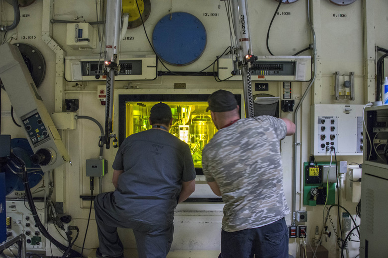 Brian Simmons, right, and Freddy Rodriguez process nuclear operators at the Idaho National Laboratory using master-slave manipulators to work with radioactive material inside a hot cell that hasn't been entered since 1974. Simmons was in the same accident with Ralph Stanton on Nov. 8, 2011, exposing him to alpha radiation-emitting americium and plutonium, which can be deadly when inhaled. (Chad Estes/McClatchy DC/Tribune News Service via Getty Images)