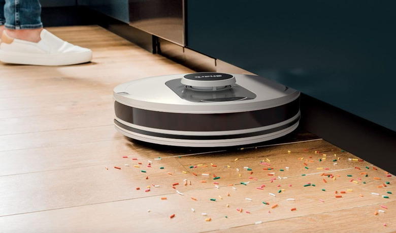 A robot vacuum cleaning up sprinkles.