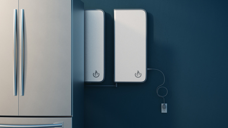 The BioLite Backup is mounted on a wall behind a fridge. 