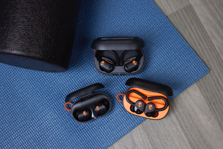 Skullcandy Active Collection, showing three sets of earbuds inside their charging cases.