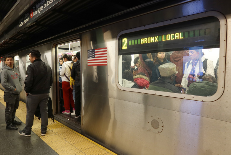 NEW YORK, NY - NOVEMBER 6: Two people wait on a platform to board a 2 train at the Times Sqaure subway station on November 6, 2023, in New York City.  (Photo by Gary Hershorn/Getty Images)