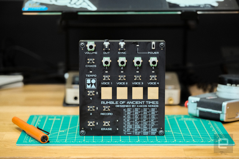 Soma Labs Rumble of Ancient Times on a desk with a fountain pen and a Canonet 35mm camera.