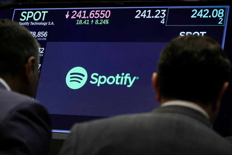 FILE PHOTO: A screen displays the logo and trading information for Spotify on the floor at the New York Stock Exchange (NYSE) in New York City, U.S., February 6, 2024.  REUTERS/Brendan McDermid/File Photo
