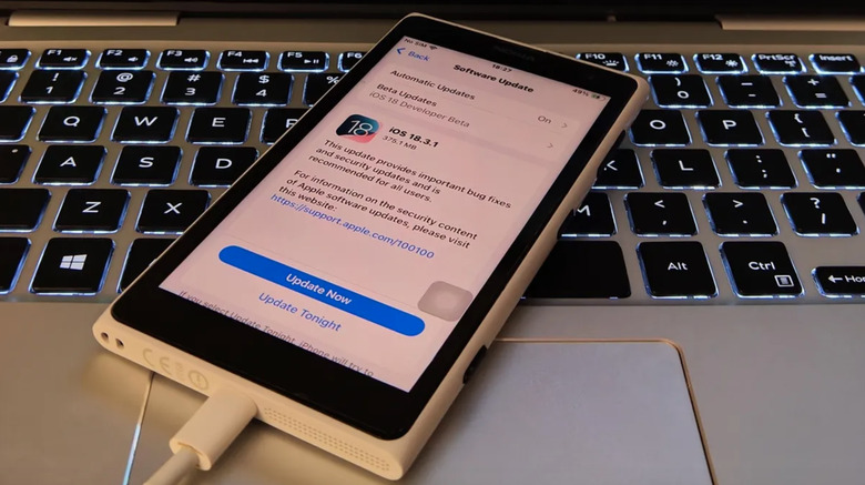 A phone on a keyboard.