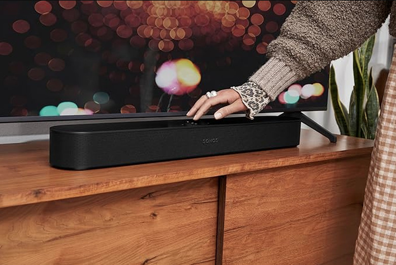 A soundbar and a lady's hand.