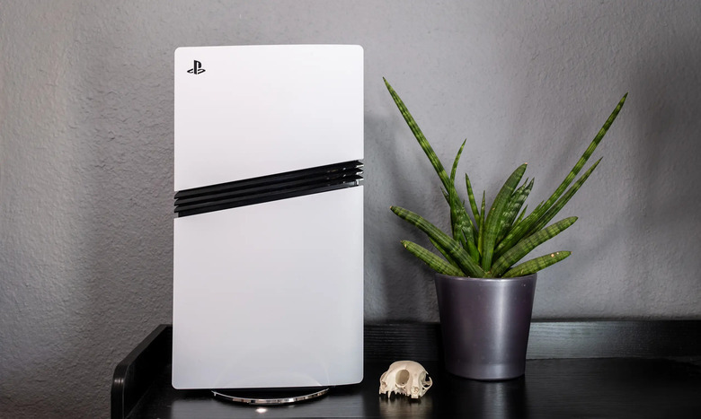 PS5 Pro next to a skull and potted plant