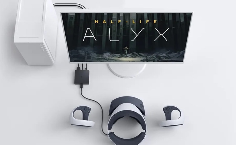 PS VR2 headset connected to a PC. The monitor shows the logo for Half-Life: Alyx.