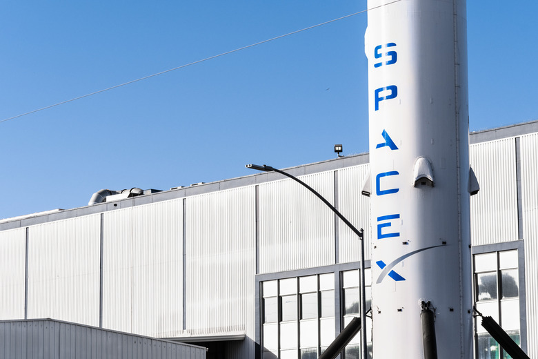 Dec 8, 2019 Hawthorne / Los Angeles / CA / USA - SpaceX (Space Exploration Technologies Corp.) headquarters; Falcon 9 rocket displayed in the front; SpaceX is a private American aerospace manufacturer