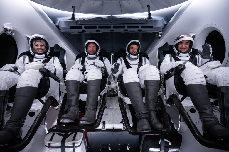 The four Polaris Dawn crew members in their spacesuits in the Dragon capsule during tests ahead of the flight