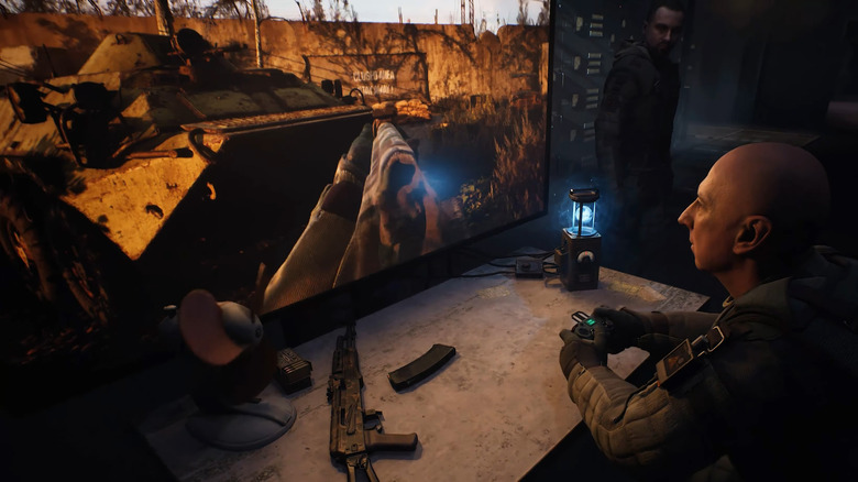 Video game trailer still. The colonel from Stalker 2 playing Stalker 2 in a meta moment.