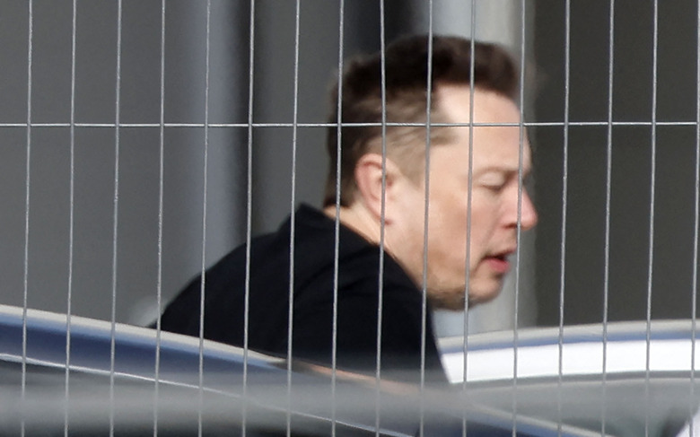 Tesla CEO Elon Musk arrives at the company's electric car plant in Gruenheide near Berlin, eastern Germany, on March 13, 2024, as employees resumed work after production had to be halted due to a suspected arson attack that caused a power outage. Damage to the lines knocked out power to the plant as well as cutting electricity to surrounding villages since power lines supplying the factory were set on fire in the early hours of March 5, 2024. Far-left activists from the 