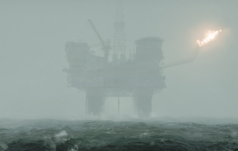 An oil rig obscured by heavy fog.