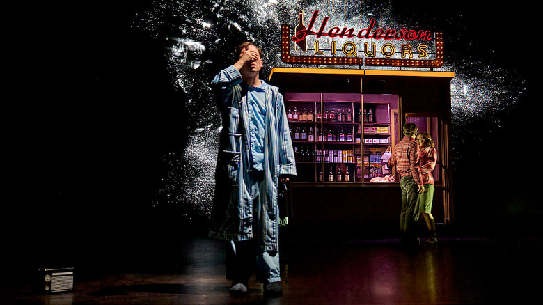 A person with his hand over his eyes.