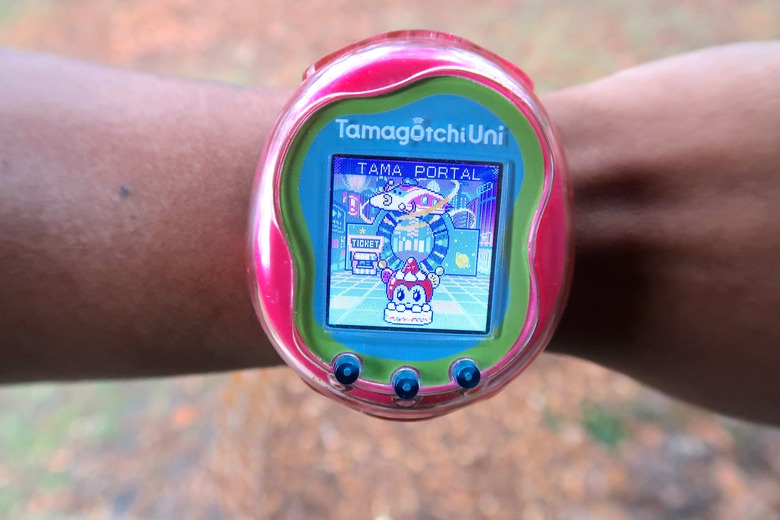 A Tamagotchi Uni worn on the wrist showing the new Tama Portal
