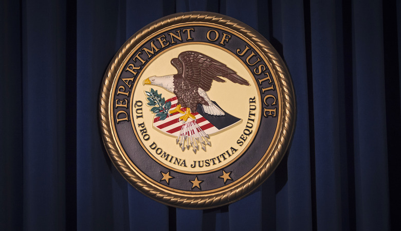 The Department of Justice (DOJ) logo is pictured on a wall after a news conference to discuss alleged fraud by Russian Diplomats in New York December 5, 2013.     REUTERS/Carlo Allegri (UNITED STATES - Tags: CRIME LAW)