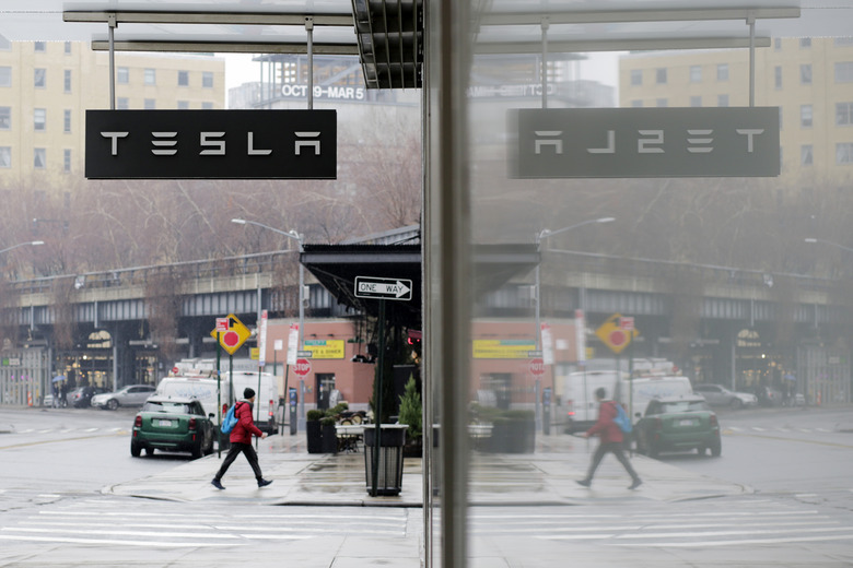 NEW YORK, NEW YORK - JANUARY 03: A man walks near Tesla showroom on January 03, 2023 in New York City. Tesla Inc. shares started 2023 by plunging more than 13% as they fell to $106.50 a share . (Photo by Leonardo Munoz/VIEWpress)