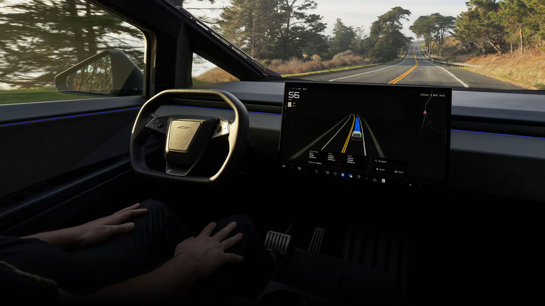 A rider using Tesla's Full Self-Driving software with their hands off the steering wheel.