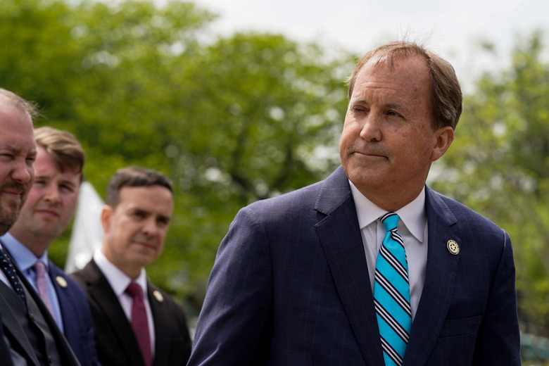 Texas Attorney General Ken Paxton pauses while speaking during a news conference after the U.S. Supreme Court heard oral arguments in President Joe Biden's bid to rescind a Trump-era immigration policy that forced migrants to stay in Mexico to await U.S. hearings on their asylum claims, in Washington, U.S., April 26, 2022. REUTERS/Elizabeth Frantz